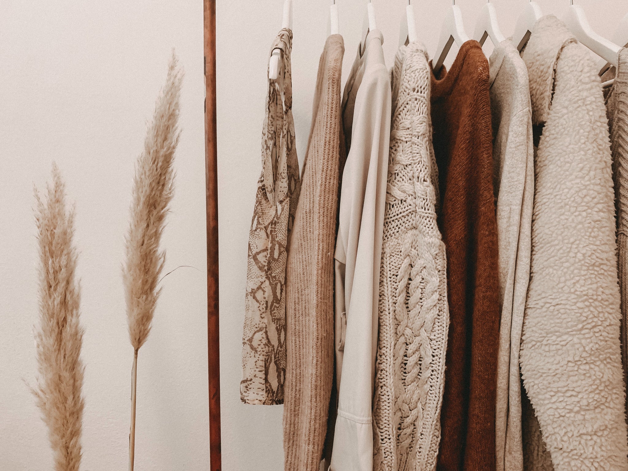 modhemian modern bohemian neutral clothes handing on clothing rack